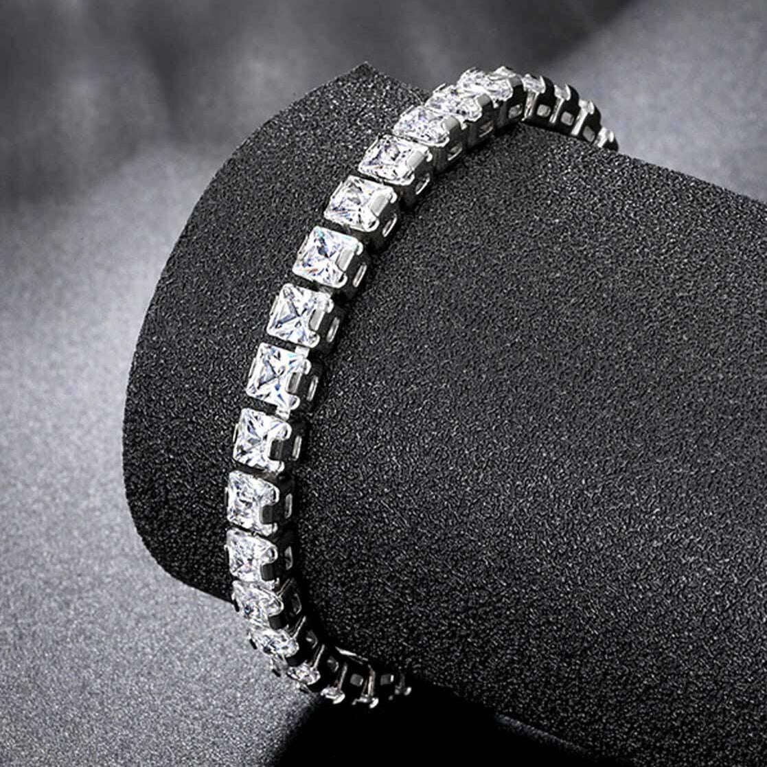 Diamond bracelet on a black stand with a dark background
