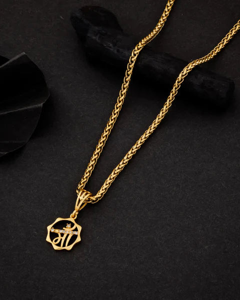 Gold necklace with a pendant on a black background