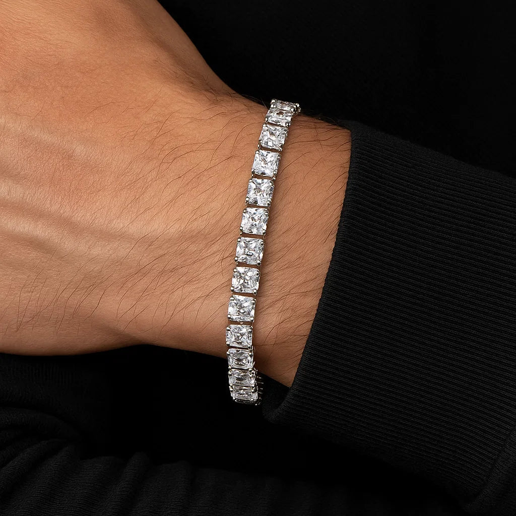 Silver bracelet with clear stones on a wrist against a black background