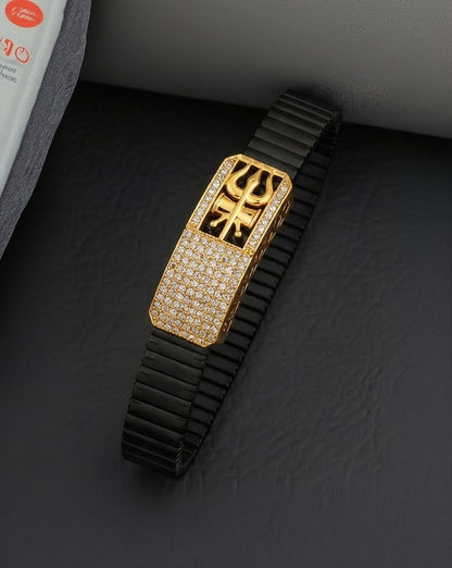 Luxury watch with black band and gold face on a dark textured background