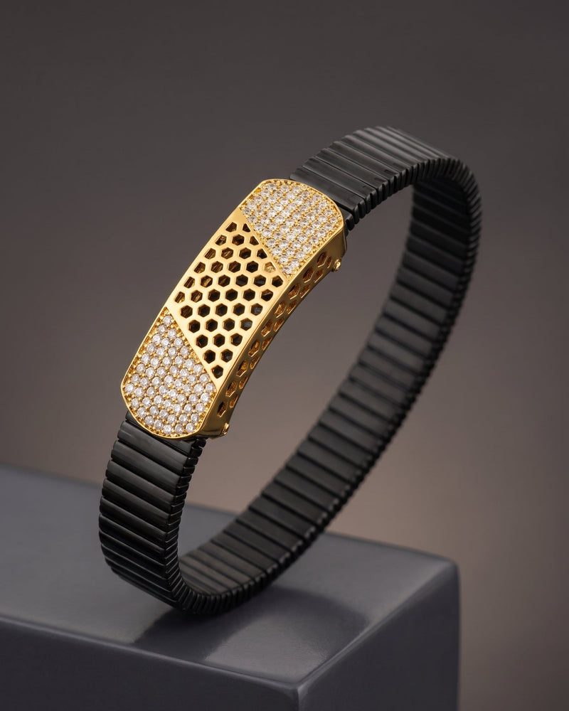 Gold and black bracelet on a dark background